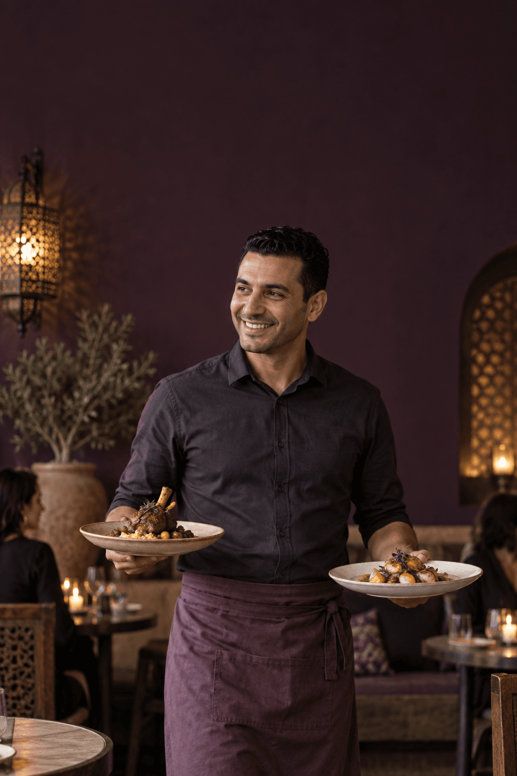 Un serveur apporte les plats à table